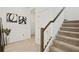 Bright hallway with carpeted stairs and decorative artwork at 2800 Cello Ln, Kissimmee, FL 34741