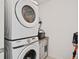 Stacked washer and dryer unit in a compact laundry space at 2800 Cello Ln, Kissimmee, FL 34741