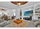 Bright living room with modern furniture, decorative ceiling fan, and entertainment center at 3131 Pawleys N Loop, St Cloud, FL 34769