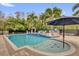 Luxury pool with tanning shelf, sun umbrella, water feature, statues and lounge seating at 3131 Pawleys N Loop, St Cloud, FL 34769