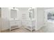 Bright bathroom with double vanity, white cabinets, marble countertops, and direct access to the pool at 411 Boxwood Dr, Davenport, FL 33837