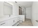 Modern bathroom with a glass-enclosed shower, large mirror, and sleek vanity at 411 Boxwood Dr, Davenport, FL 33837