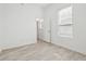 A bright bedroom with light-colored floors and a window letting in ample natural light at 411 Boxwood Dr, Davenport, FL 33837