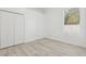 Bright bedroom showcasing a closet, a window bringing in natural light, and light-colored floors at 411 Boxwood Dr, Davenport, FL 33837