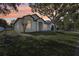 Beautiful single-story home with a manicured lawn and mature trees in a serene suburban setting at 411 Boxwood Dr, Davenport, FL 33837