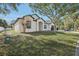 Well-maintained single-story home with lush front lawn and mature landscaping at 411 Boxwood Dr, Davenport, FL 33837