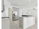 Bright kitchen featuring marble countertops, stainless steel appliances, and a kitchen island at 411 Boxwood Dr, Davenport, FL 33837