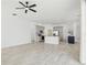 Open-concept living area featuring tile floors, a ceiling fan, and modern kitchen at 411 Boxwood Dr, Davenport, FL 33837