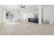 Bright, open-concept living area with tile floors, modern island, and easy access to the screened lanai at 411 Boxwood Dr, Davenport, FL 33837