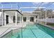 Inviting pool with a screened-in enclosure and a spacious patio area at 411 Boxwood Dr, Davenport, FL 33837