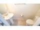 Well-lit half bathroom featuring a pedestal sink, and modern fixtures, for convenience at 4138 Lana Ave, Davenport, FL 33897