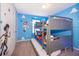 Themed bedroom with a bunk bed, cloud decor, and vibrant blue walls at 4138 Lana Ave, Davenport, FL 33897