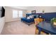 Comfortable bedroom featuring a queen bed, stylish decor, and a blue accent wall at 4138 Lana Ave, Davenport, FL 33897