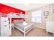 Fun bedroom featuring a bunk bed, playful decor, and a red accent wall at 4138 Lana Ave, Davenport, FL 33897