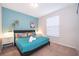 Bedroom with turquoise accent wall, queen bed and matching nightstands at 4138 Lana Ave, Davenport, FL 33897