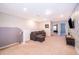 Upstairs bonus room featuring a comfortable sofa, media center, neutral carpet, and relaxed atmosphere at 4138 Lana Ave, Davenport, FL 33897