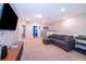 Spacious bonus room with neutral carpet, a comfortable sofa, media center, and easy access to multiple bedrooms at 4138 Lana Ave, Davenport, FL 33897