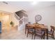 Cozy dining area featuring a wooden table, comfortable seating, and a view of the staircase at 4138 Lana Ave, Davenport, FL 33897