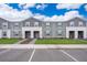 Gray townhome exteriors feature manicured lawns, sidewalks, and convenient parking at 4138 Lana Ave, Davenport, FL 33897