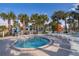 Community hot tub with lounge chairs and umbrellas for a relaxing vacation lifestyle at 4138 Lana Ave, Davenport, FL 33897