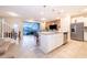 Open-concept kitchen with white cabinets, granite countertops, and stainless appliances at 4138 Lana Ave, Davenport, FL 33897