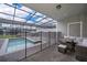 Relaxing screened pool area with outdoor seating, a -safety fence, and serene surroundings at 4138 Lana Ave, Davenport, FL 33897