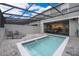 Inviting screened pool area with outdoor lounge chairs and a -safety fence around the pool at 4138 Lana Ave, Davenport, FL 33897