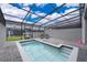 Inviting screened pool area with lounge chairs and a -safety fence surrounding the pool and deck at 4138 Lana Ave, Davenport, FL 33897