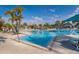 Community zero-entry swimming pool with comfortable lounge chairs and umbrellas for a relaxing vacation lifestyle at 4138 Lana Ave, Davenport, FL 33897