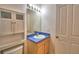Bathroom features modern vanity with blue counter and bright vanity lighting at 500 Monroe Cir, Davenport, FL 33896
