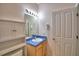 Functional bathroom with a vanity sink, overhead lights and convenient storage cabinet at 500 Monroe Cir, Davenport, FL 33896