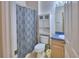 Bathroom featuring a blue patterned shower curtain and matching blue-trimmed vanity at 500 Monroe Cir, Davenport, FL 33896