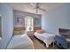 Shared bedroom with twin beds, ceiling fan, and window offers a cozy retreat at 500 Monroe Cir, Davenport, FL 33896