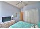 Comfortable bedroom featuring a ceiling fan, closet, TV and ample storage space at 500 Monroe Cir, Davenport, FL 33896