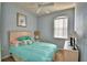 Inviting bedroom with a comfortable bed, ceiling fan, and natural light from the window at 500 Monroe Cir, Davenport, FL 33896