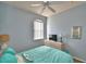 Serene bedroom features a window, TV, bedside table, dresser, and lots of natural light at 500 Monroe Cir, Davenport, FL 33896