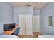 Cozy bedroom featuring a built-in desk, closet, and soothing light blue walls at 500 Monroe Cir, Davenport, FL 33896