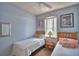 Shared bedroom with comfortable twin beds and a sunny window provides a cozy retreat at 500 Monroe Cir, Davenport, FL 33896