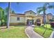 Community clubhouse entrance with manicured landscaping and sidewalk at 500 Monroe Cir, Davenport, FL 33896