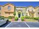 Charming townhome with colorful facade, well-maintained landscaping, and convenient parking at 500 Monroe Cir, Davenport, FL 33896