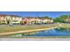 View of townhomes in a neighborhood along a pond at 500 Monroe Cir, Davenport, FL 33896