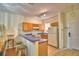 Well-equipped kitchen with wooden cabinets, breakfast bar, and convenient access to the entryway at 500 Monroe Cir, Davenport, FL 33896