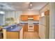 Functional kitchen with wood cabinets, modern appliances, and a breakfast bar at 500 Monroe Cir, Davenport, FL 33896