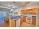 Bright kitchen featuring a breakfast bar, wooden cabinetry, and tile flooring adjacent to the living area at 500 Monroe Cir, Davenport, FL 33896