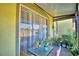 Relaxing covered patio features lush plants and sliding glass doors to the interior at 500 Monroe Cir, Davenport, FL 33896