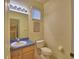 Charming half bath with a blue countertop vanity and toilet at 500 Monroe Cir, Davenport, FL 33896