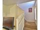 Carpeted stairway with a Mickey Mouse artwork hanging on the wall at 500 Monroe Cir, Davenport, FL 33896