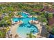 Aerial view of a large community pool with many lounge chairs and umbrellas at 5117 Oakbourne Ave, Davenport, FL 33837