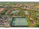 Aerial view of community pool and tennis courts with neighborhood homes in the background at 5117 Oakbourne Ave, Davenport, FL 33837