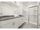 Bright bathroom featuring a granite countertop, double sinks and walk in shower at 5117 Oakbourne Ave, Davenport, FL 33837